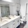 Bathroom with double vanity and white cabinets