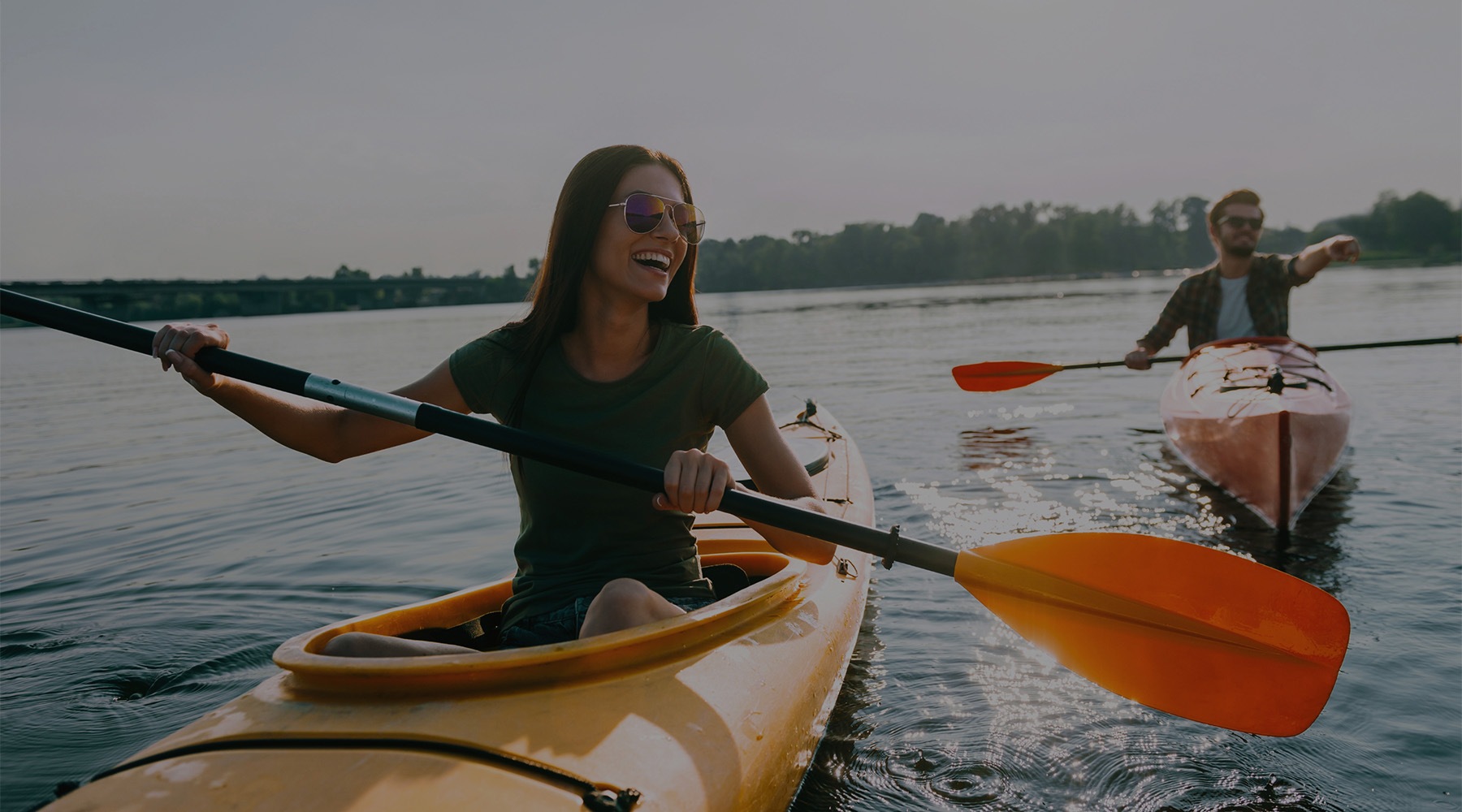 Two people kayaking near Hominy RiverBlue apartments in Asheville, NC