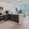 kitchen with dark bottom and white upper cabinets
